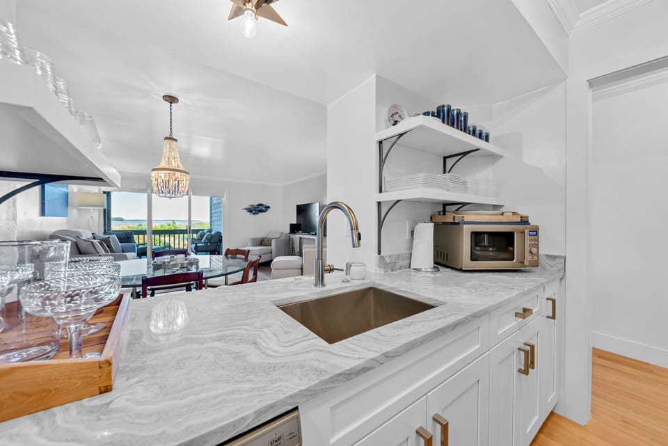 The kitchen pass through lets you look out to the great room and the ocean beyond the sliders!