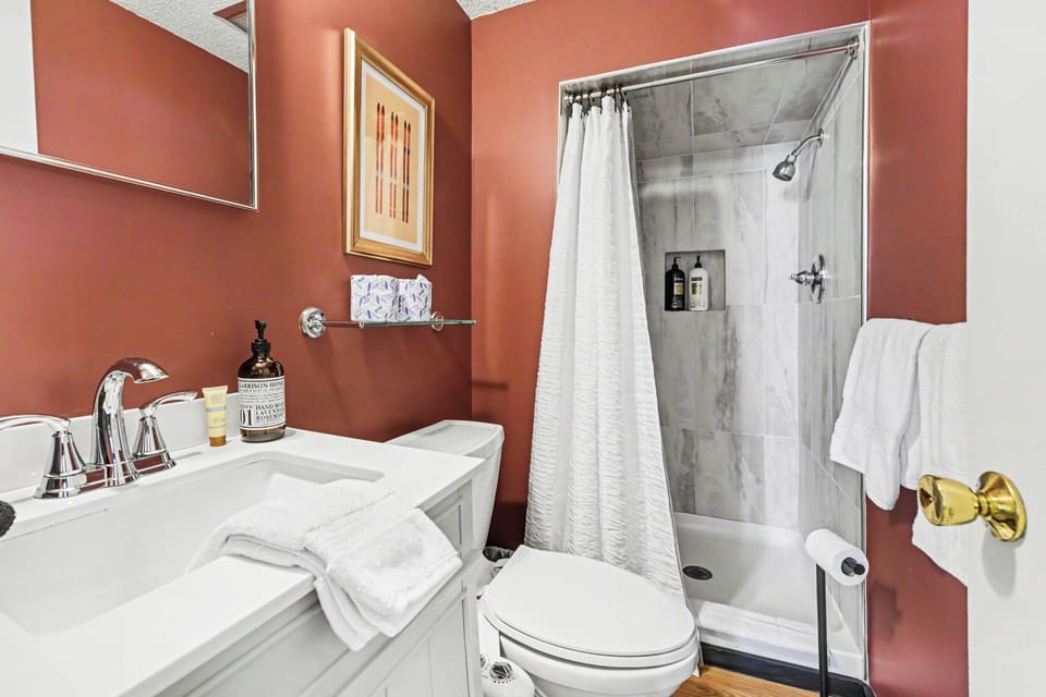 Bathroom with vanity, toilet, and shower at Sugarloaf Chalet in Arcadia, Michigan