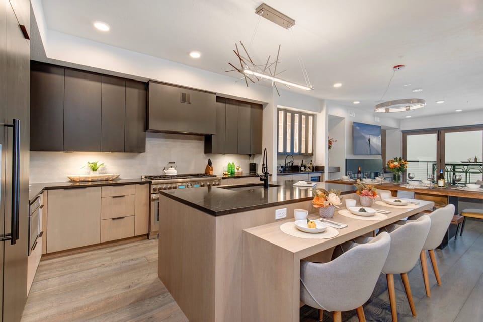 Fully Equipped Kitchen with high-end stainless steel appliances, a SubZero refrigerator with ice maker, gorgeous stone counter tops, and bar seating for four.