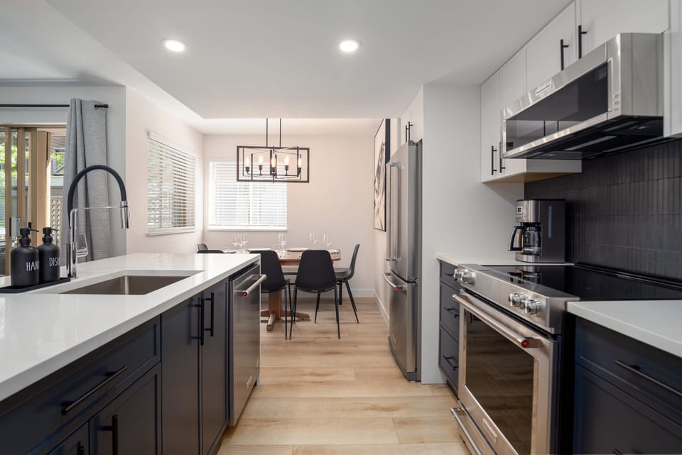 Kitchen and Dining- Open concept kitchen allows for easy entertaining with plenty of seating in the dining room or at the kitchen bar. Brand new KitchenAid appliances.
