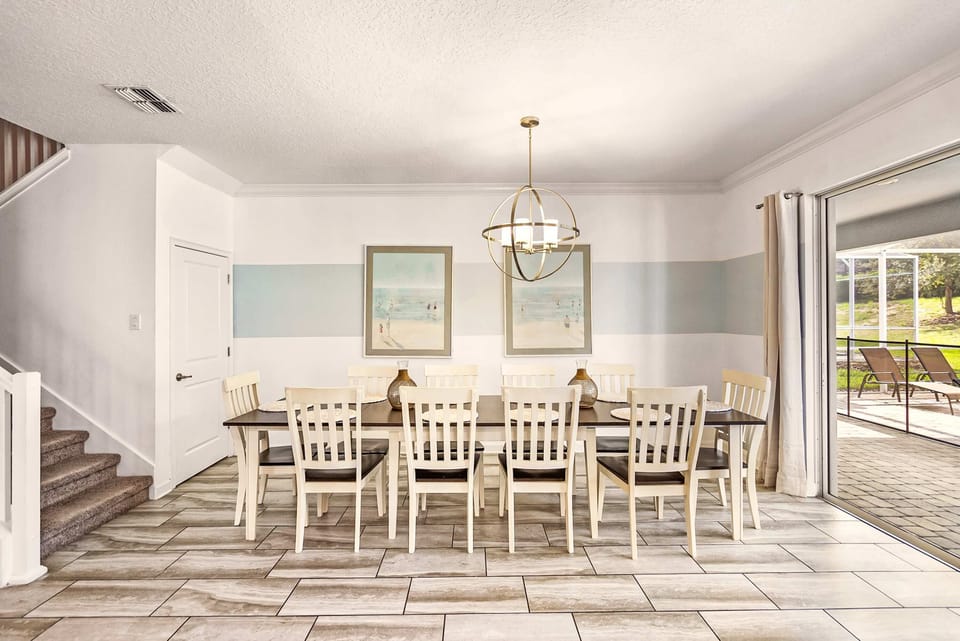 Elegant dining room with seating for 10, perfect for gatherings, opening to a sunny patio for seamless indoor-outdoor living.