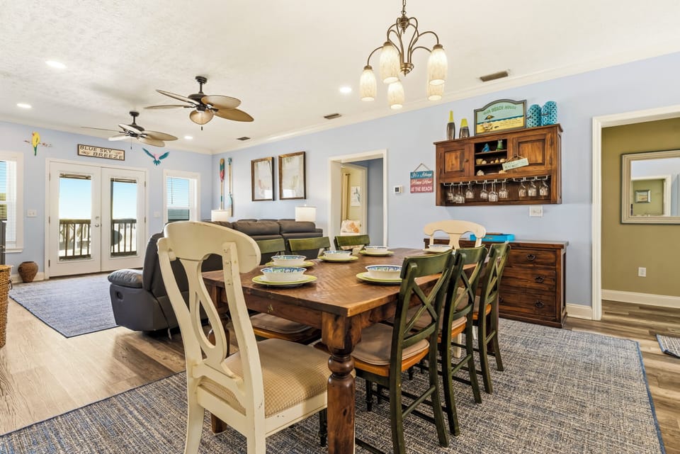 Gather around your elegant dining table where morning coffee and evening meals become cherished moments in this beautifully appointed space.