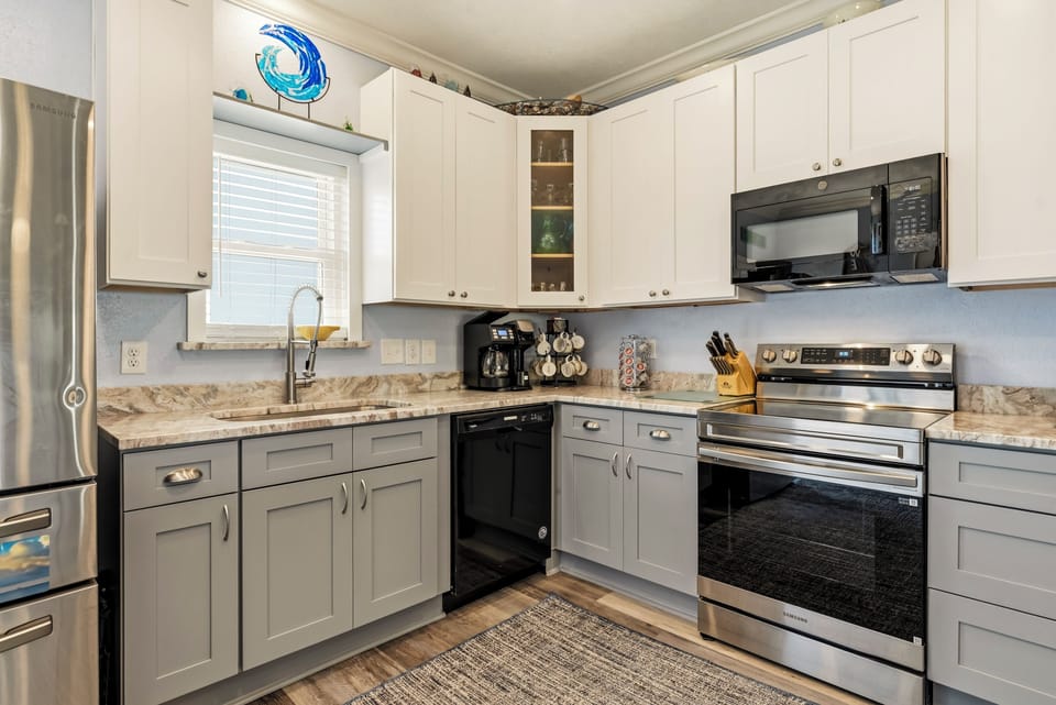 Your spacious kitchen features stainless steel appliances, granite counters, and modern cabinets—perfect for cooking memorable meals during your stay.