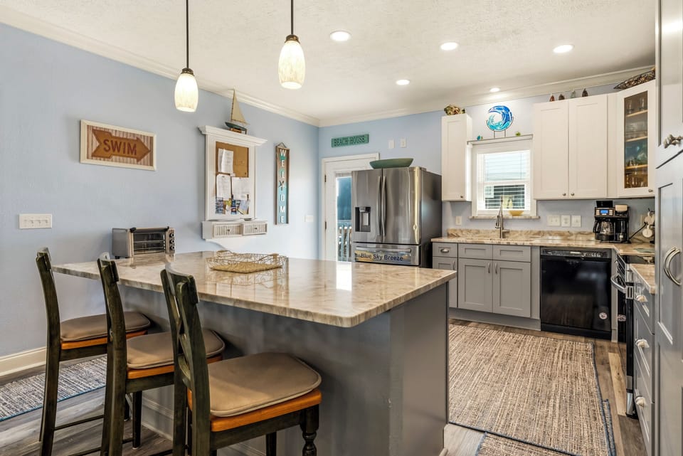 Cook and gather in this spacious kitchen with granite counters, stainless appliances, and a breakfast bar perfect for your morning coffee.