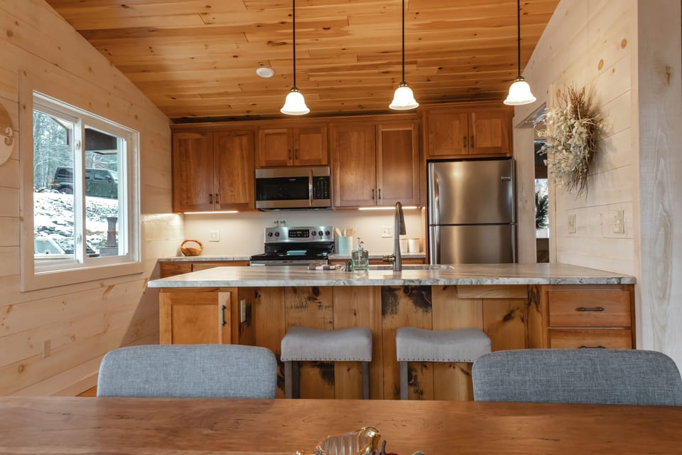 Bar area seating with open concept kitchen & dining area