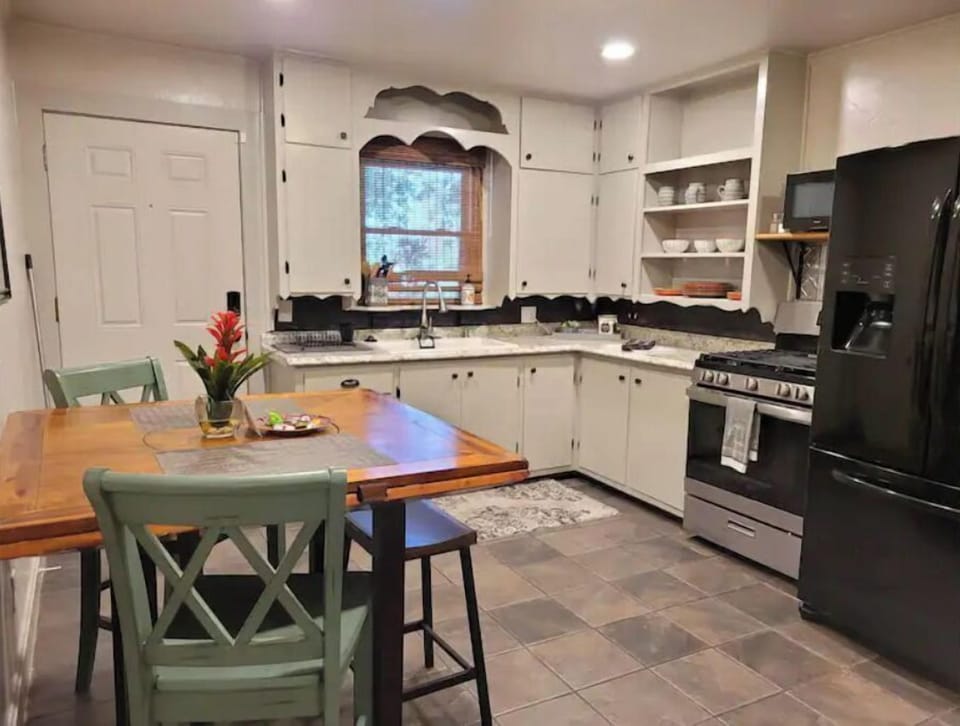 FULLY STOCKED KITCHEN, INCLUDING MICROWAVE, KEURIG, GAS OVEN WITH GRIDDLE.