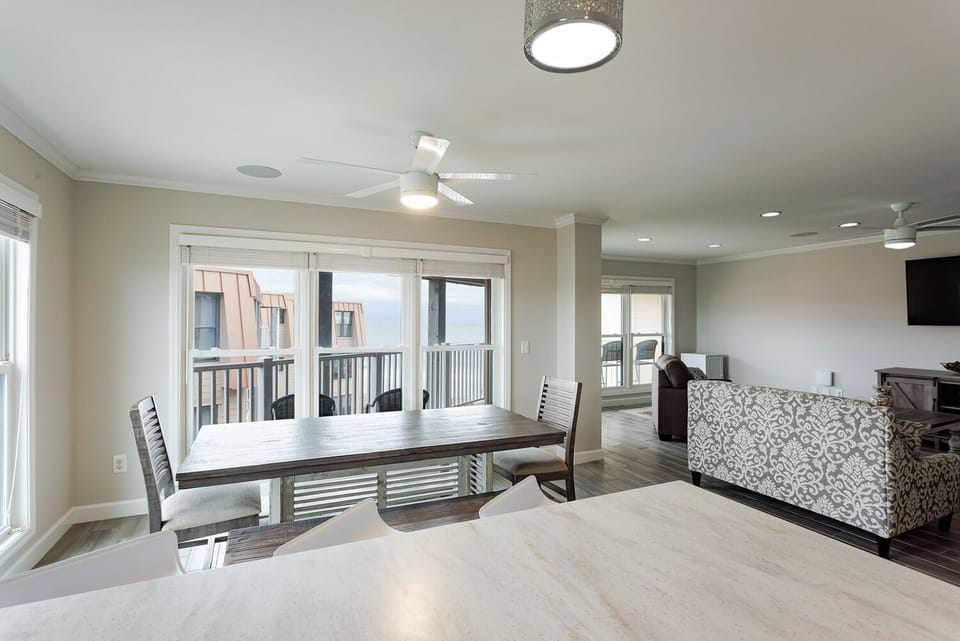 View from kitchen overlooking the living & dining rooms w/ partial ocean view.