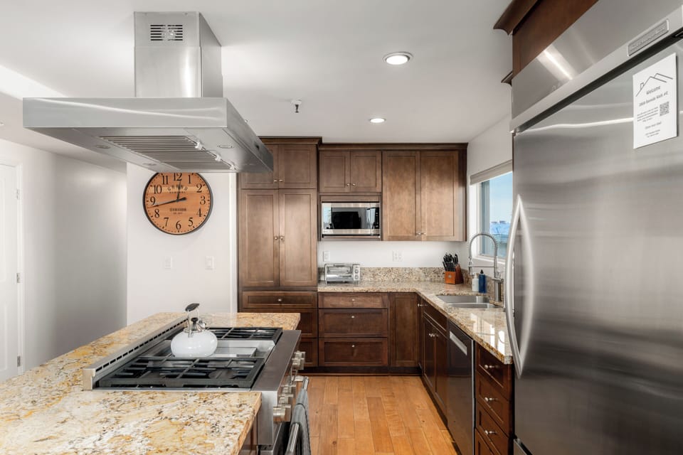 Kitchen with gas stove/range, dishwasher, dual Keurig & drip coffee pot and kitchen essentials.