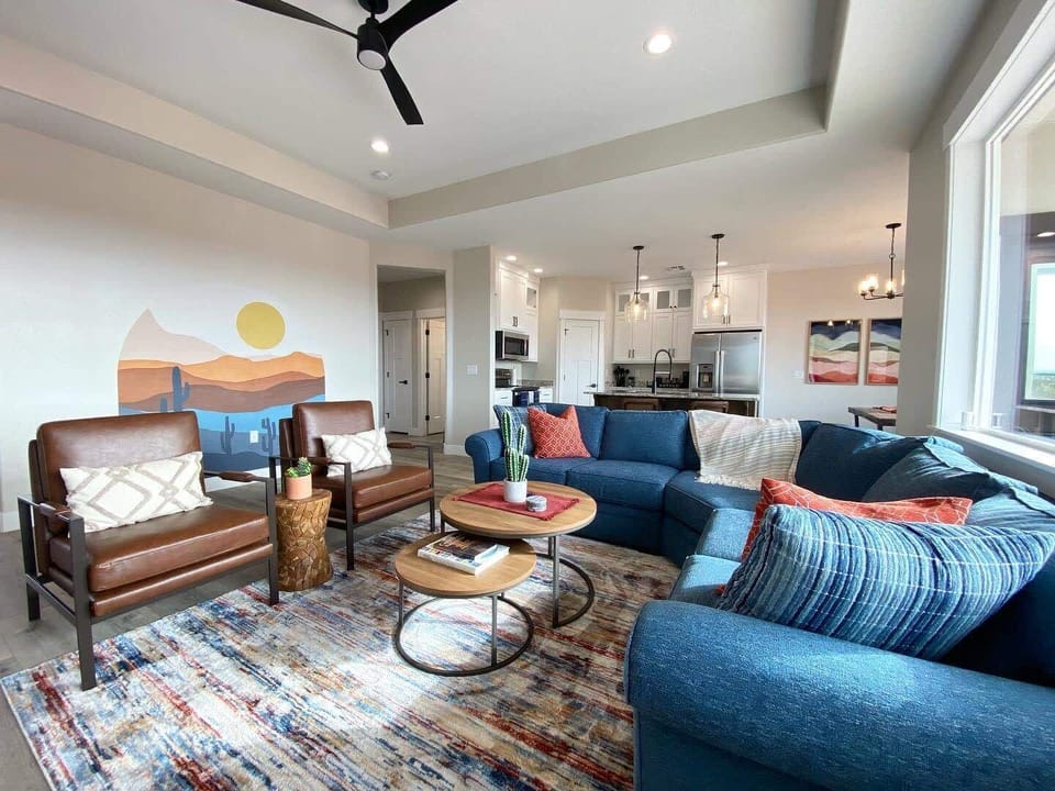 Gather and relax. This open living area offers ample natural light, plenty of space to spread out, and comfy seating.
