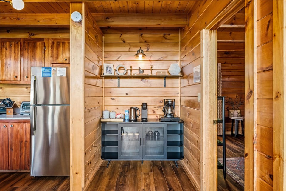 Coffee bar with drip and Keurig, and a full-size fridge right beside it.