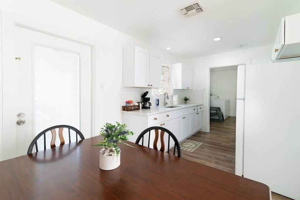 Spacious kitchen and dining area with plenty of natural light, fully equipped for home-cooked meals.