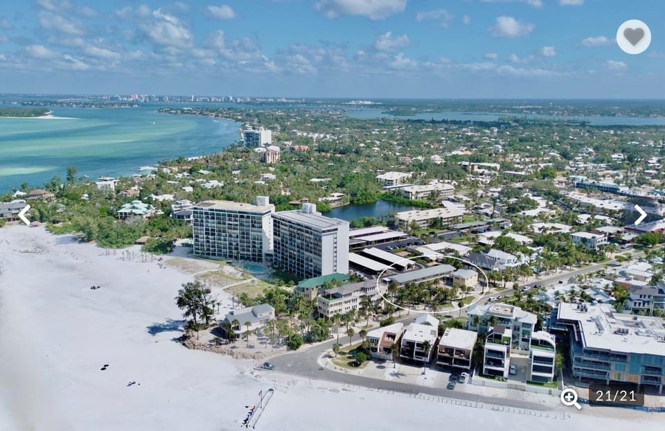 Stunning beachfront property offers direct beach access and panoramic coastal views in this vibrant waterfront community.