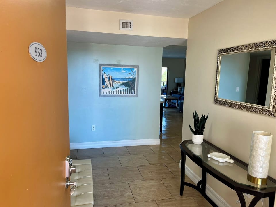 Step into your welcoming entryway with coastal artwork and thoughtful touches that immediately make you feel at home.
