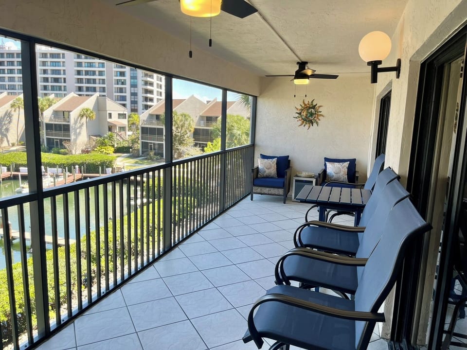 Unwind on your private screened balcony with plush seating and waterfront views—perfect for morning coffee or sunset cocktails.