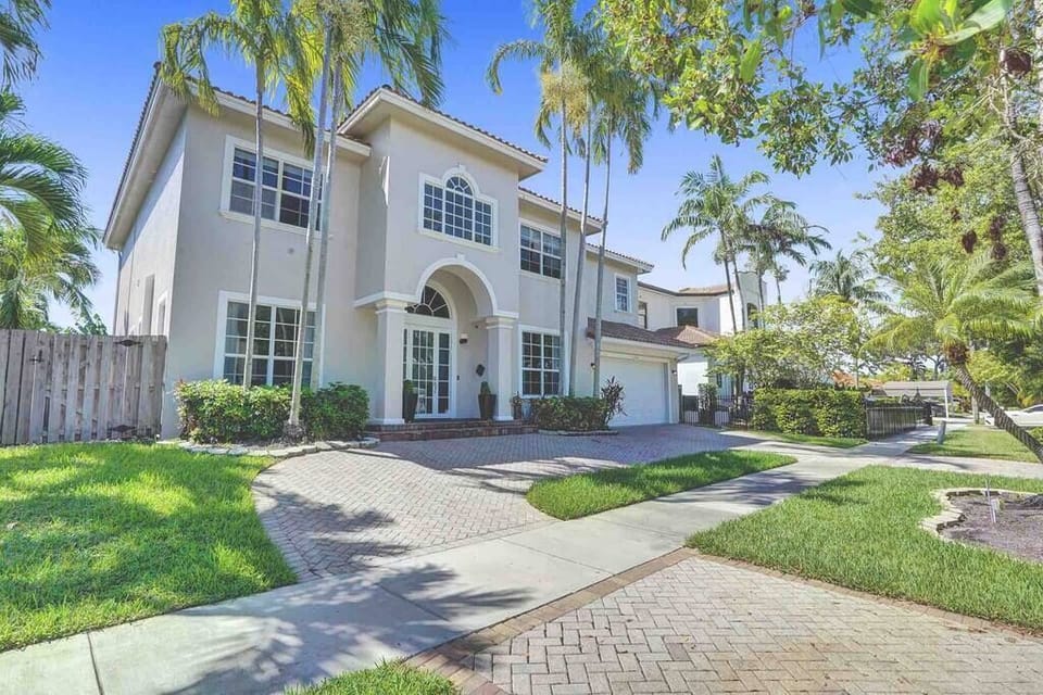 Elegant luxury home with beautiful landscaping at the entrance. Discover your dream vacation retreat.