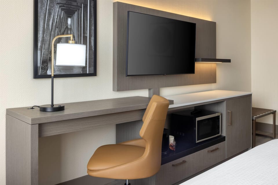 Premium bedding, laptop workspace, blackout drapes, soundproofing
