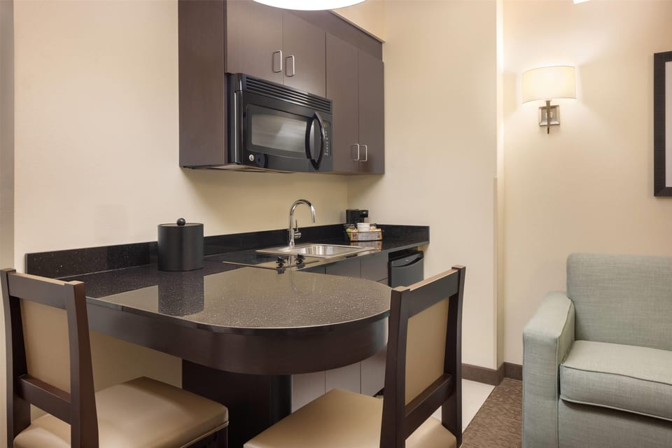 Premium bedding, laptop workspace, blackout drapes, soundproofing