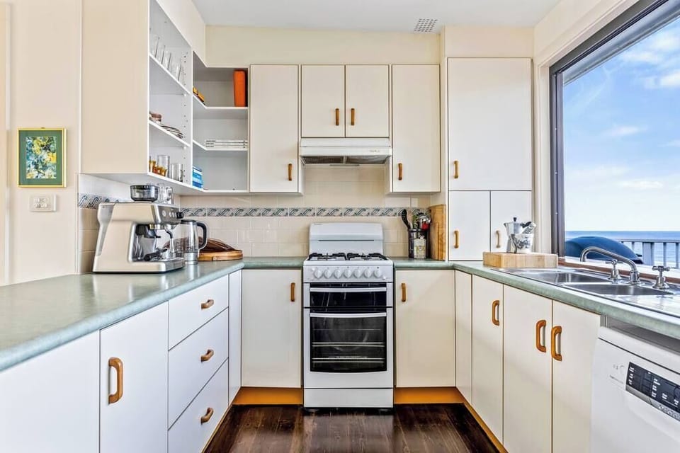 The full open plan kitchen opens onto the living areas inside and  bi fold window with stunning ocean views, large deck with relaxed seating and dining table. Perfect for BBQ's and alfresco dining to enjoy what Austinmer has to offer.  