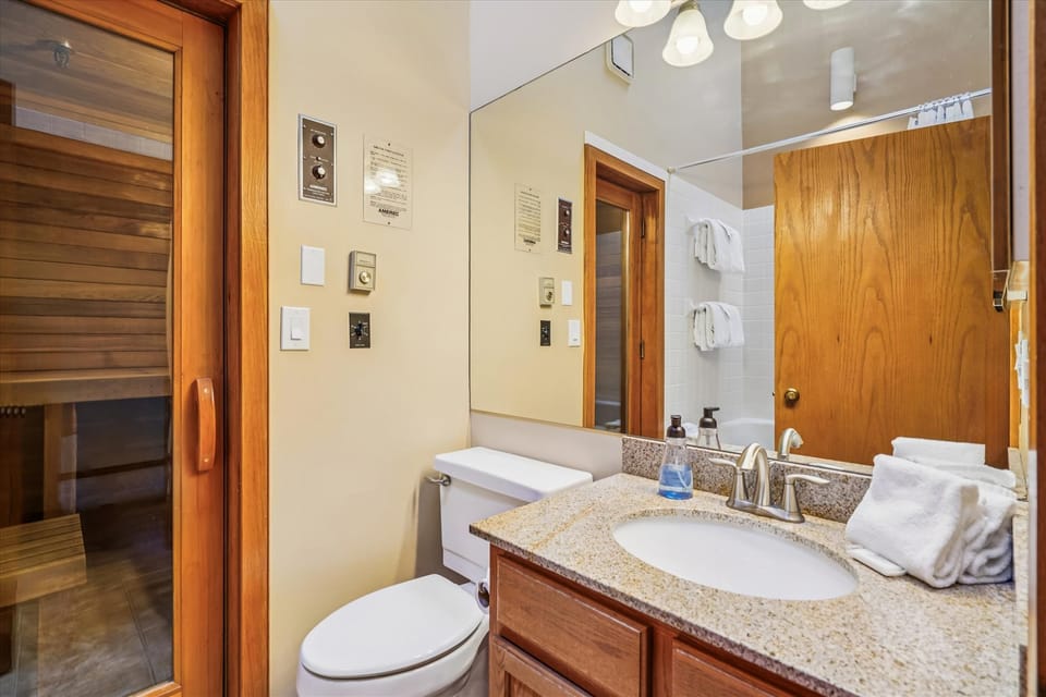 Bathroom with Sauna Access - Full bathroom with granite vanity and direct access to the private sauna.