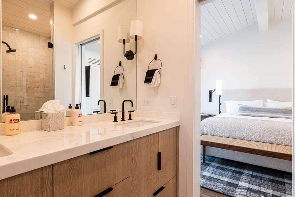 Top Floor Master 1 Suite with King size bed, private deck, 50" TV, and en suite bathroom with double sinks and tile & glass shower