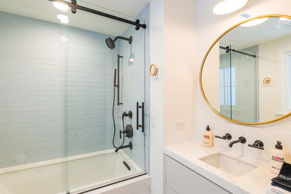 Level 3 Master Bedroom 2 with King size bed, 50" TV, and en suite bathroom with tub/shower combo