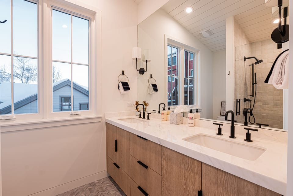 Top Floor Master 1 Suite with King size bed, private deck, 50" TV, and en suite bathroom with double sinks and tile & glass shower