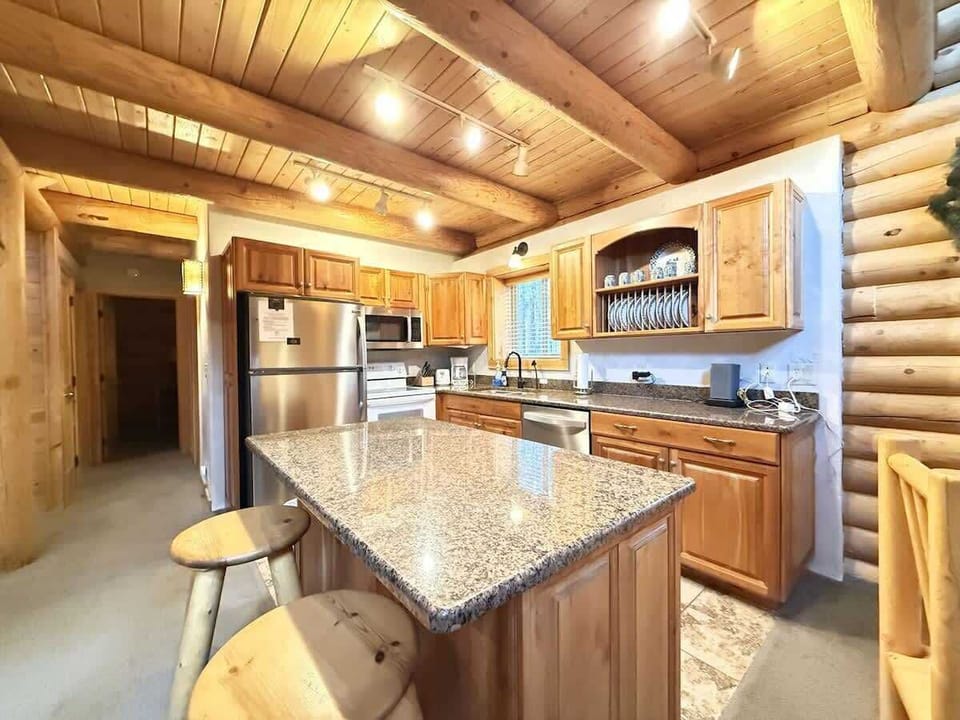 Very open kitchen with appliances, pots and pans, basic cooking essentials, dishes, and utensils.