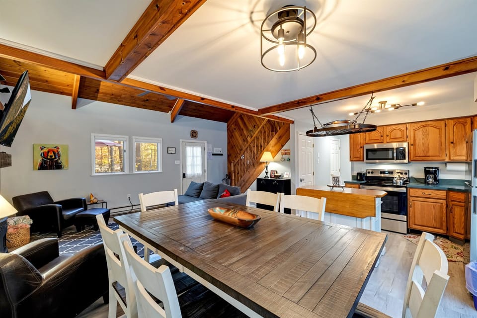 Dining area featuring a raised table and chairs, providing a stylish and comfortable space for meals and gatherings