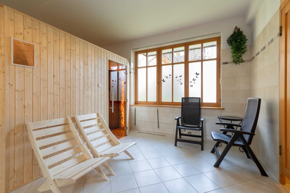 A relaxation room with wooden recliners, offering a peaceful space for unwinding.