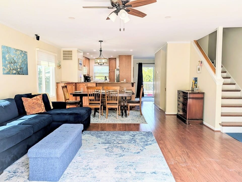 39562 Admiral Road, Tower Shores, North Bethany - living - A spacious and bright living area featuring a modern fireplace, vaulted ceilings, and a large sectional sofa—perfect for gathering the whole family.