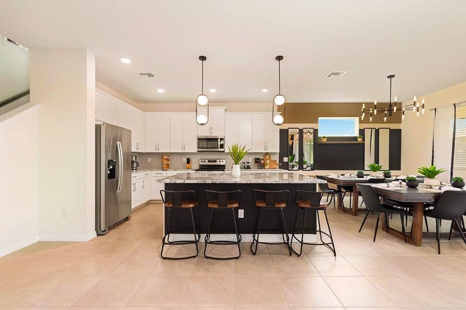 Elegant kitchen and dining area perfect for large gatherings, featuring modern appliances and ample seating.