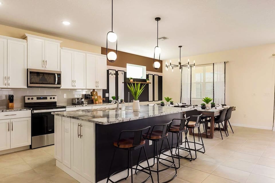 Elegant kitchen with a spacious island and dining area, perfect for family gatherings and entertaining.