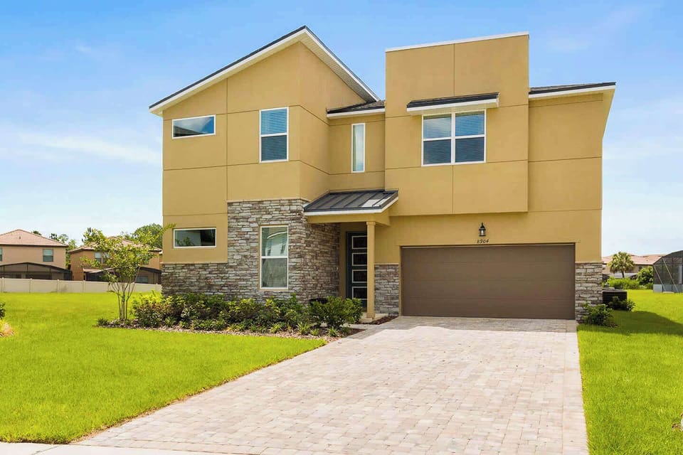 Stunning modern villa with spacious garage and manicured lawn, perfect for large gatherings and family vacations.