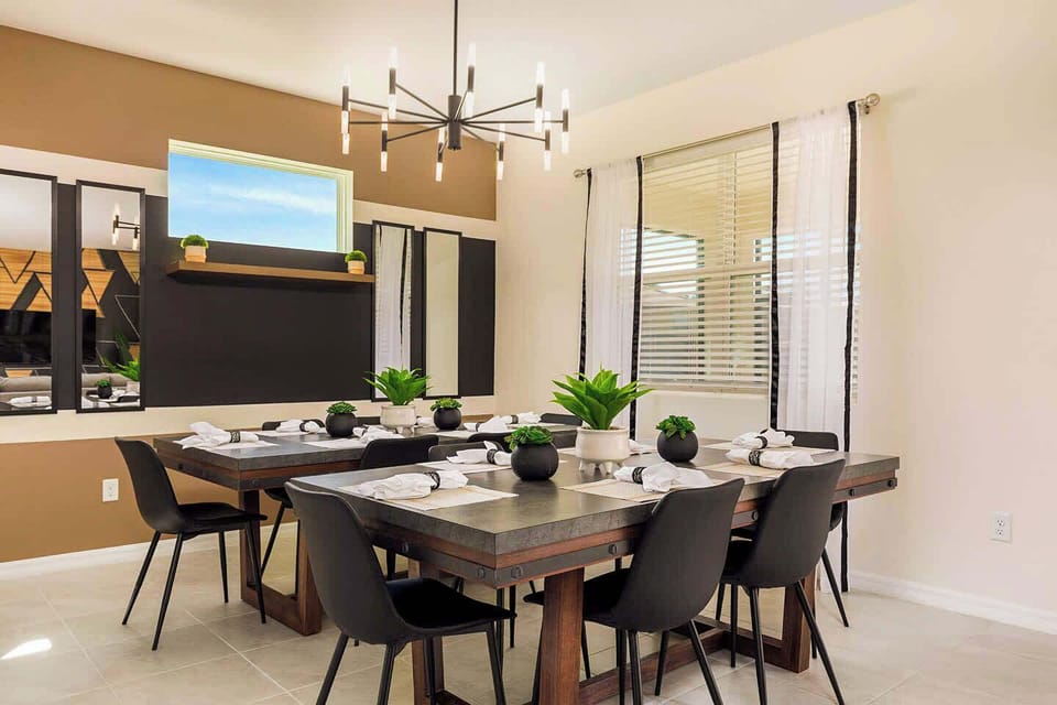Elegant dining room perfect for family gatherings, featuring a stylish table, modern decor, and abundant natural light.
