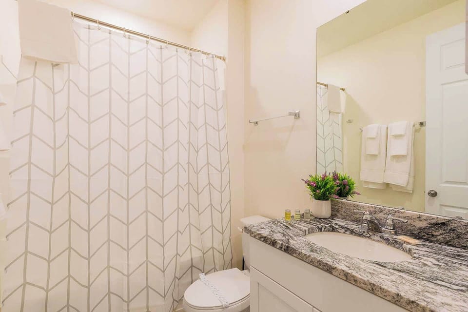 Elegant bathroom with granite countertops and modern decor, perfect for a refreshing start to your day.