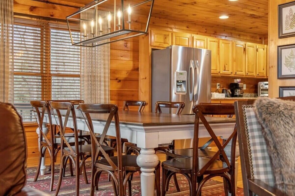 This space is accented with thoughtful décor that complements the cabin's overall rustic charm, giving you the perfect place to enjoy memorable meals.