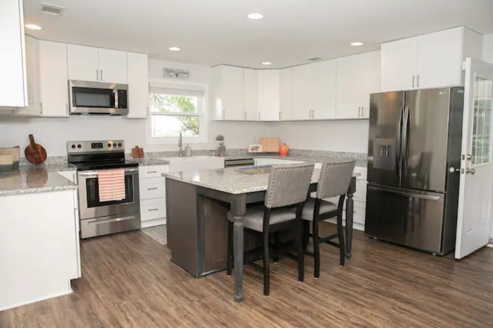 An updated, large kitchen with new appliances and a U-shape and island layout