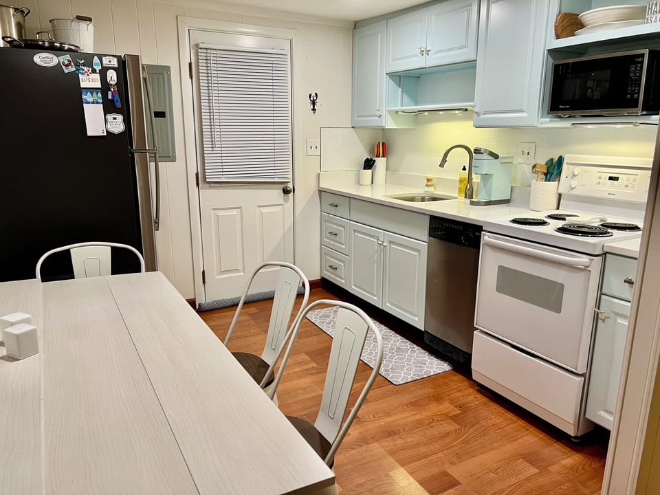 Kitchen features a table with drop down leaves to fit to 6 people.