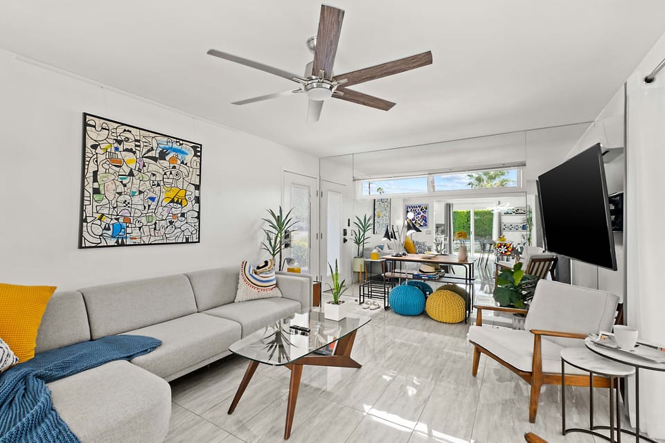 Pool view, cozy seating, large TV, dining for six, and a fully-equipped bar trolley