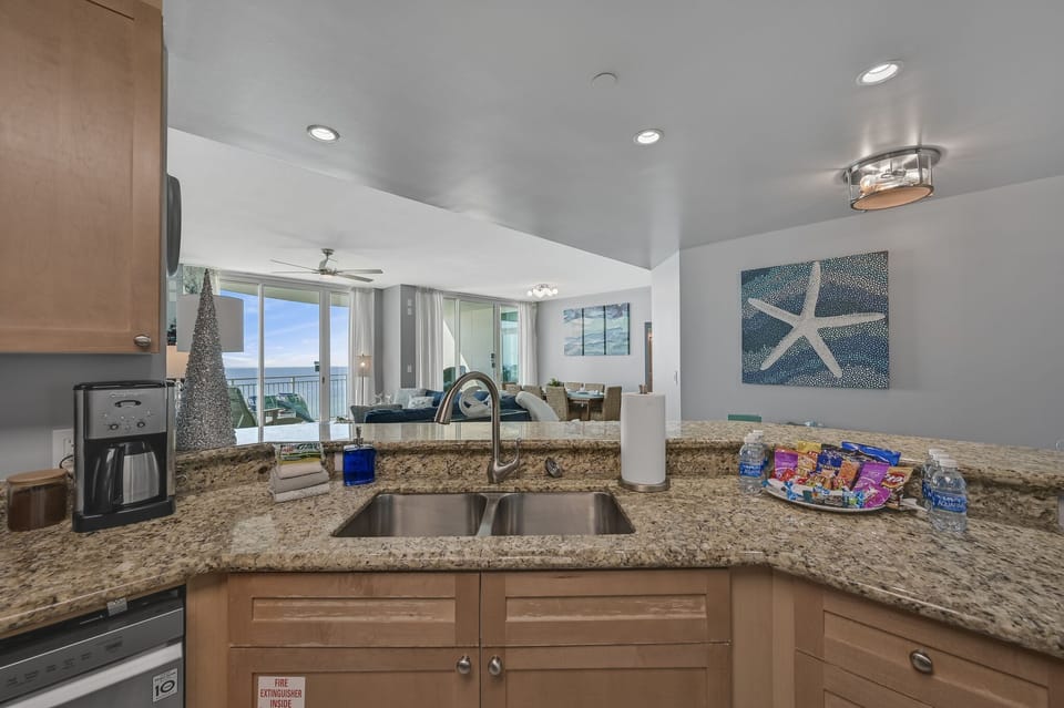 The updated kitchen has granite countertops, stainless steel appliances, and is fully stocked with more than the basics (coffee/tea bar, oils/spices, Tupperware, plenty of pots/pans/cookware)