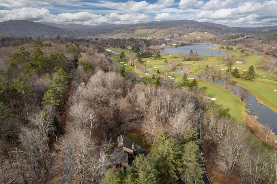 Aerial view of the property overlooking Lakeland Golf Course, Lake Pinneo, and the Green Mountains