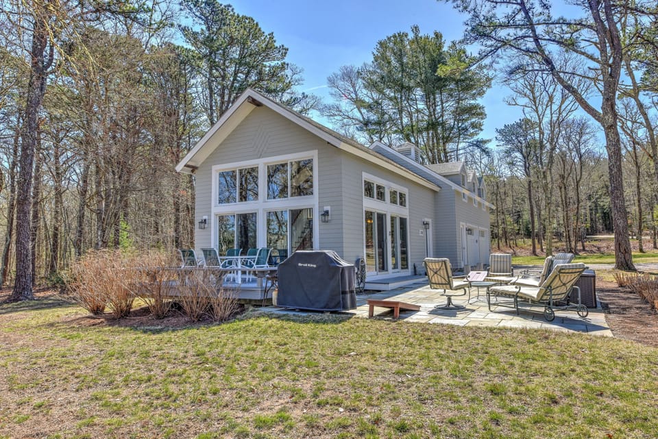 Back view of house with patio and grill.