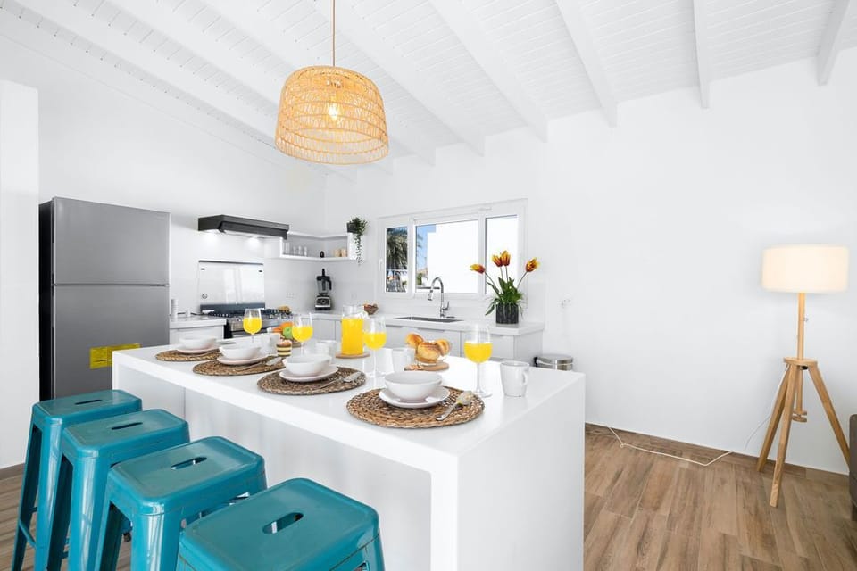 A very big kitchen island with a bar countertop and 4 counter heights.