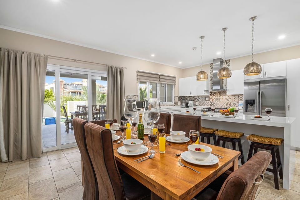There is a 6-seater dining table with upholstered chairs.