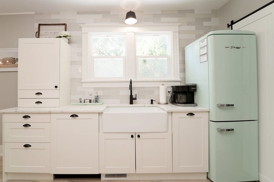 It’s the Classic Retro style appliances that really ties in the vintage charm. The kitchen is fully stocked, including a Keurig duo, crockpot, blender, and toaster.