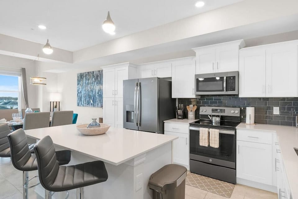 Kitchen & Island with Barstools#Disney #Parks #kingdom #springs #StoreyLake #Apartment #Vacation #Rental #waterpark #Kissimmee #Orlando #universal #citywalk