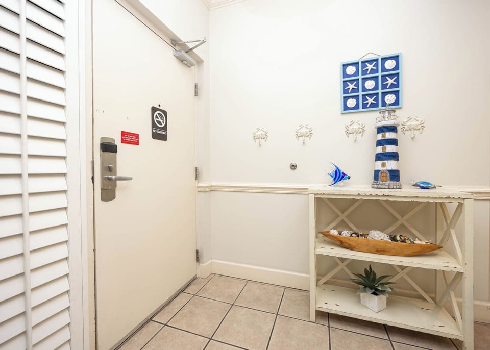 Step into this welcoming entryway, adorned with coastal decor, setting the tone for your relaxing getaway