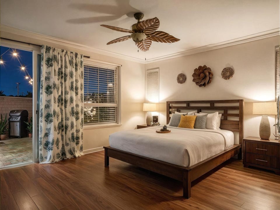 King bedroom with ensuite bath, walk-in closet and access to patio