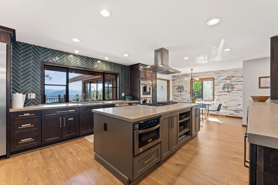 Modern chef’s kitchen with large island, stylish finishes, and bright dining nook
