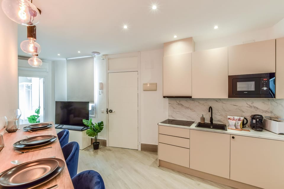 Main view of kitchen space with appliances and high top dining table